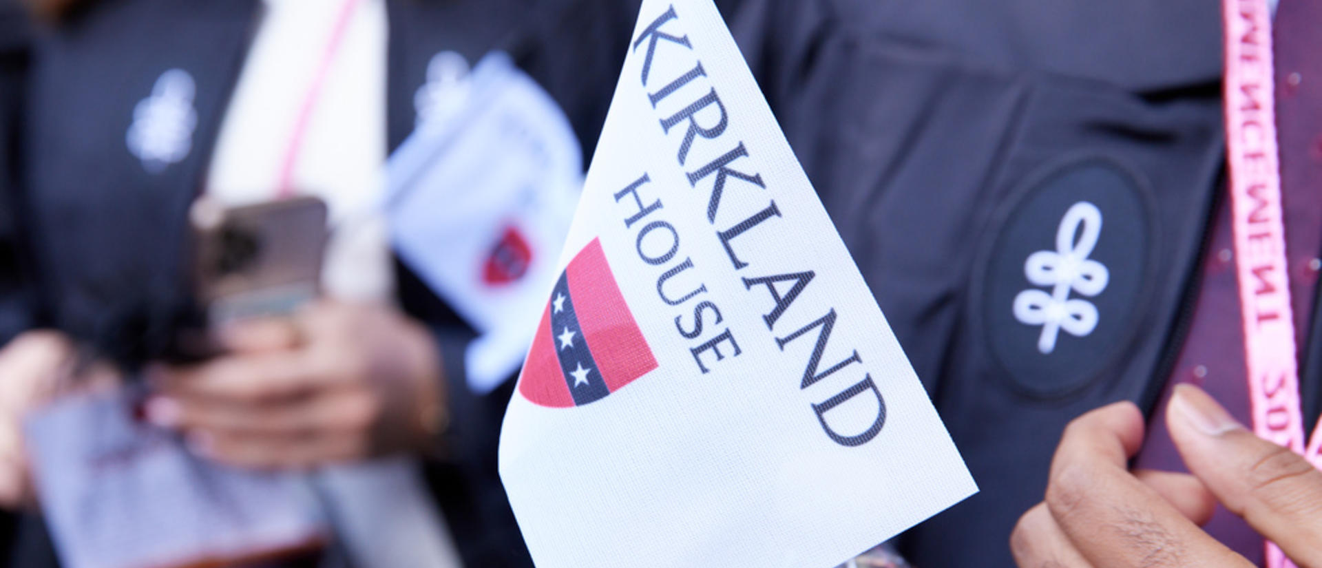 closeup of a person holding a kirkland house flag